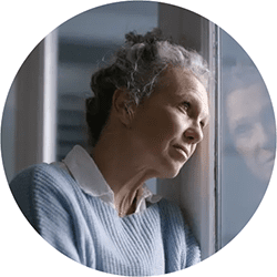 sad woman looking out window - depression treatment